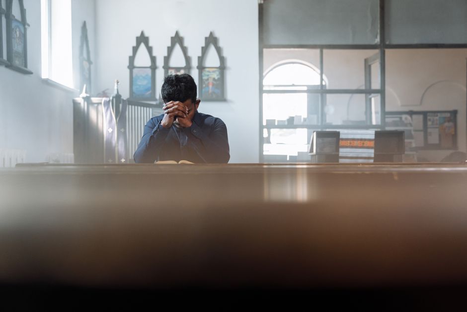 A person in quiet prayer, experiencing peaceful surrender and hope